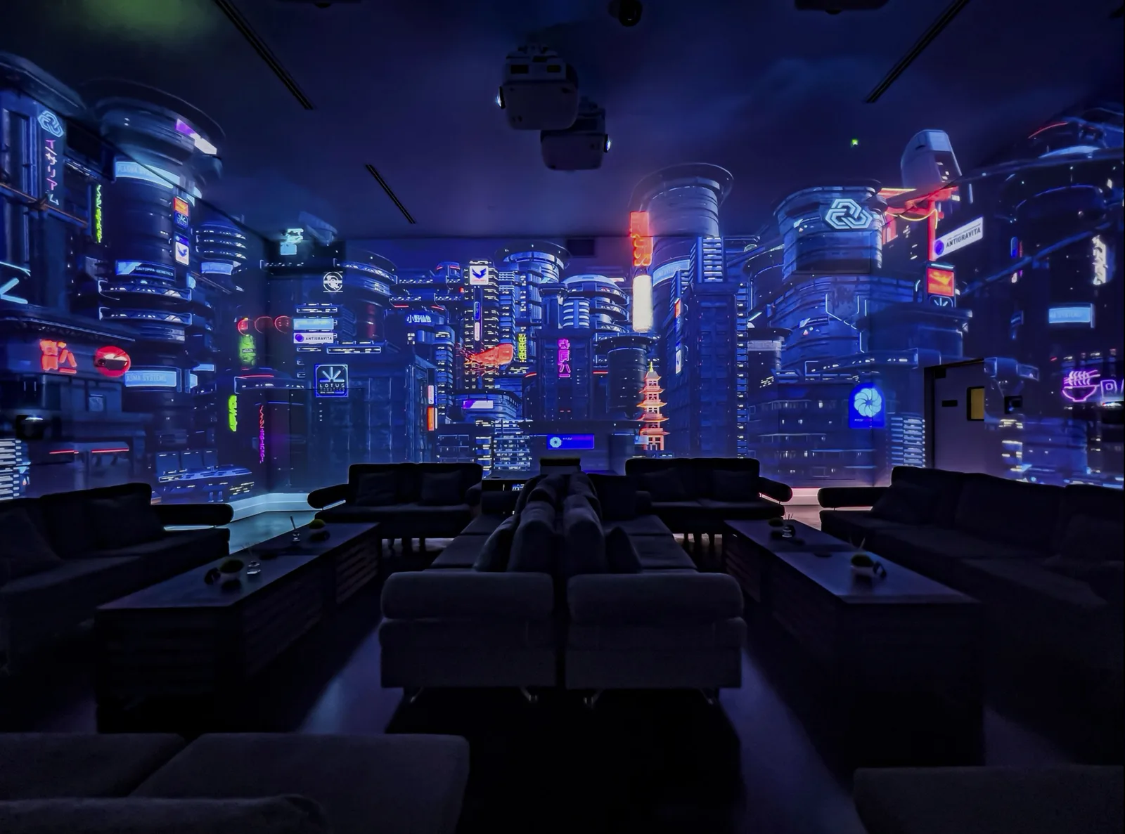 Immersive blue cityscape projection surrounding a lounge seating area.