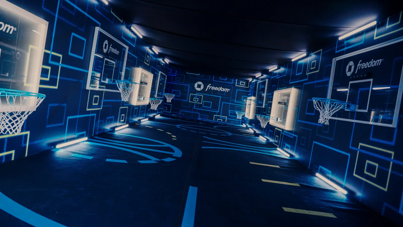 A blue immersive room with luminous wall lines receding toward the center.