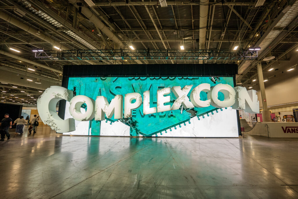 A wide digital display with oversized ComplexCon lettering inside the exhibition hall.