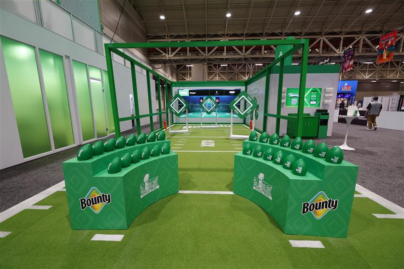 Green Bounty-branded barriers line a football activity area.