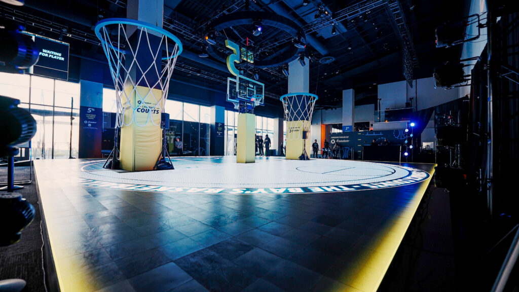 A wide view of basketball hoops and the illuminated Chase court.