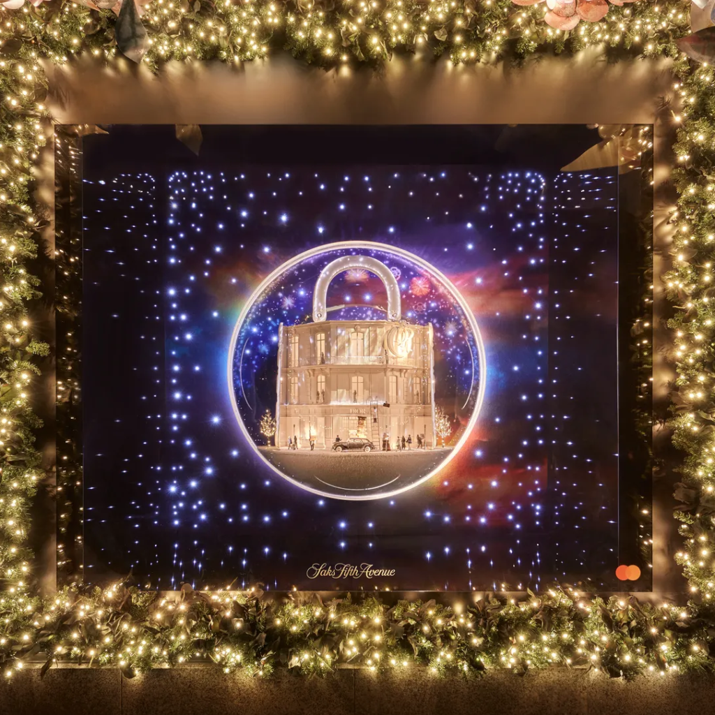 A Dior holiday window shows a golden handbag within a glowing circular display.