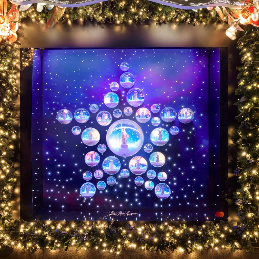 A Dior holiday window displays a tree-shaped arrangement of colorful circular scenes.