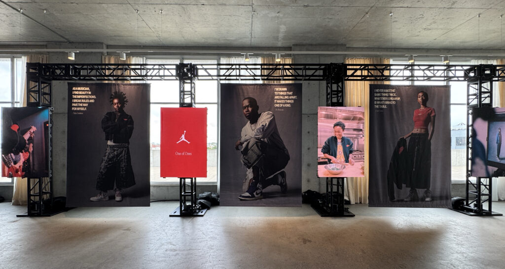 Fashion photography and a central Jordan display line the event space.
