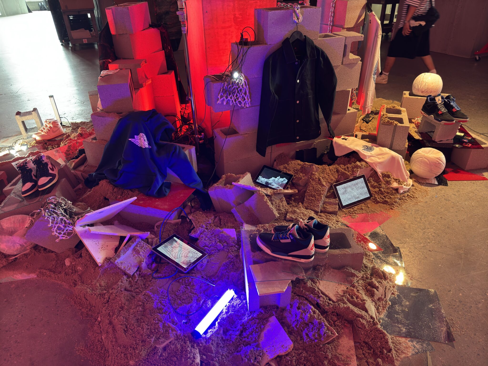 Jordan apparel and footwear arranged among red and purple illuminated display elements.