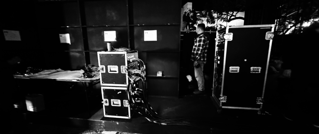 A black-and-white view of equipment cases and displays during the LeBron activation setup.