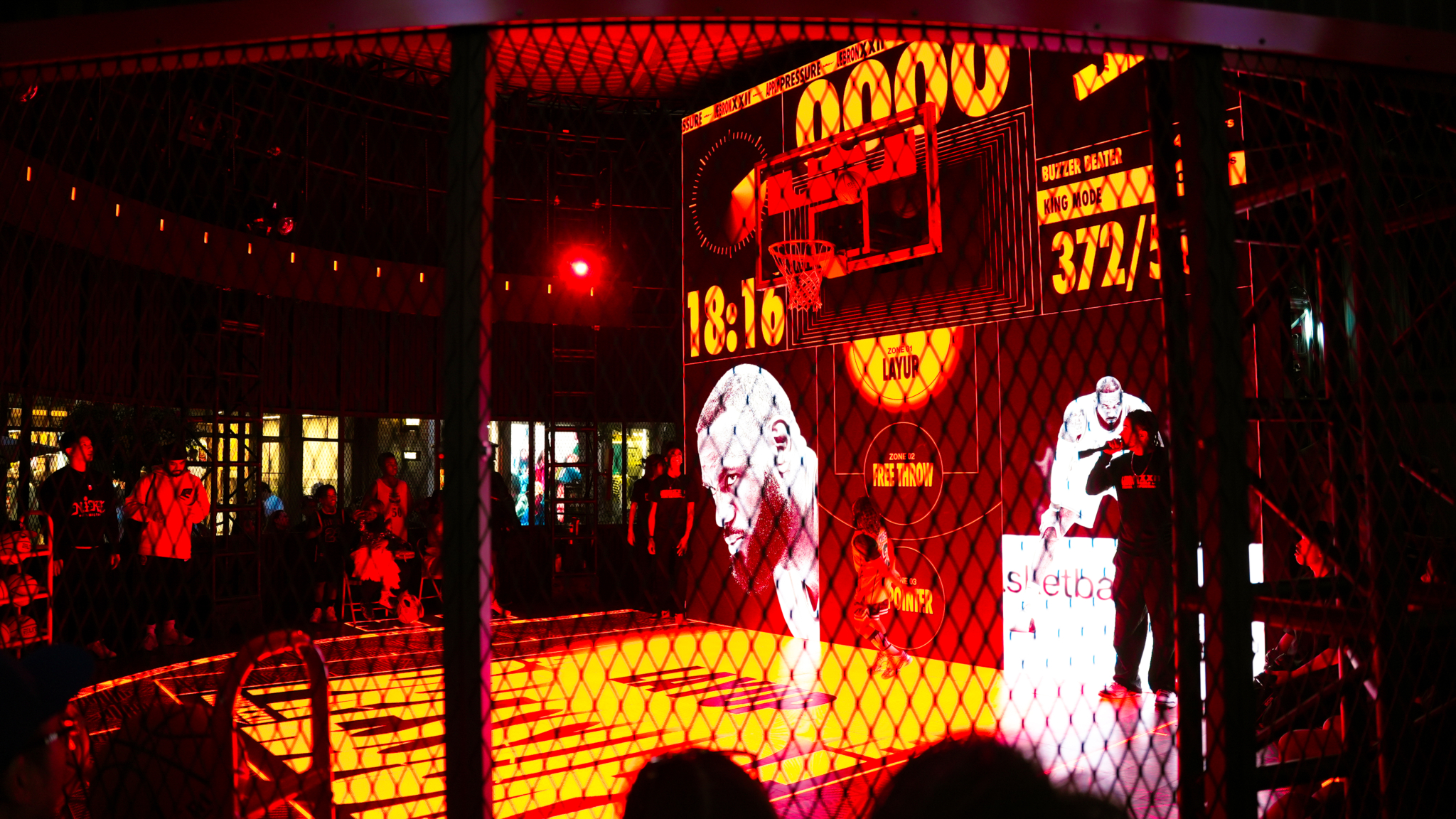 Red illuminated displays and basketball graphics surround the LeBron x Nike experience.