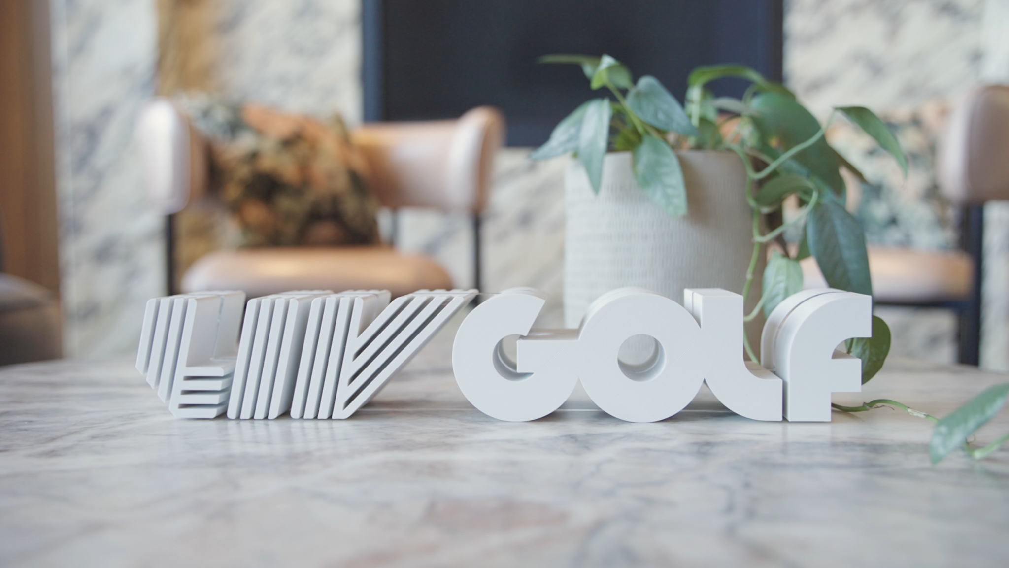 A white LIV Golf wordmark sits on a table at the event.
