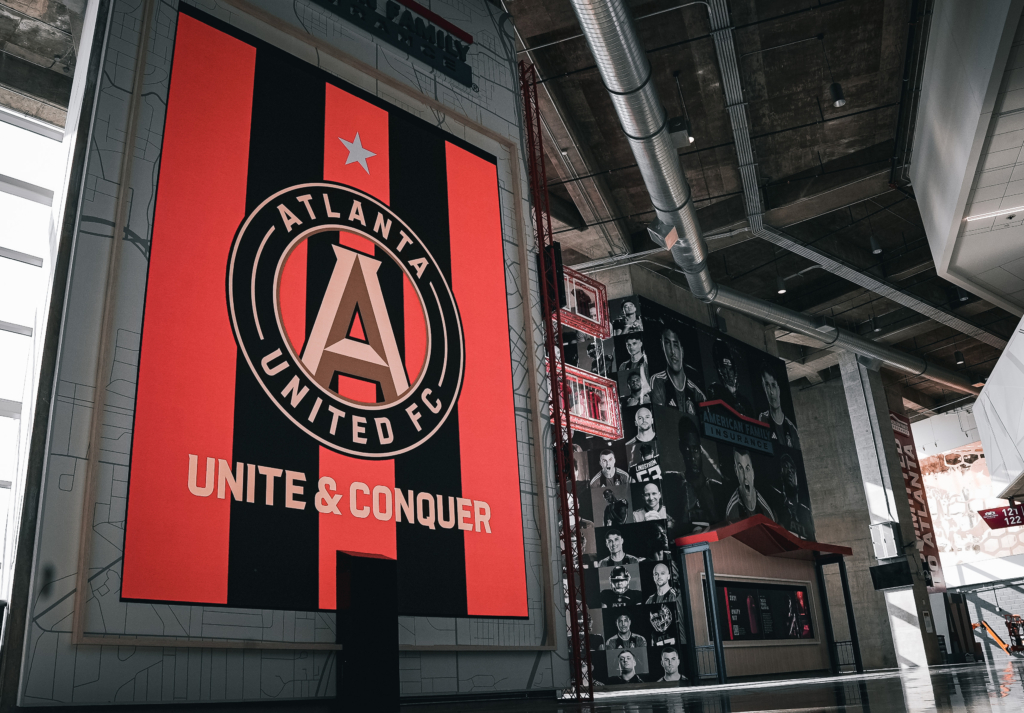 A tall red and black Atlanta United FC display inside Mercedes-Benz Stadium.