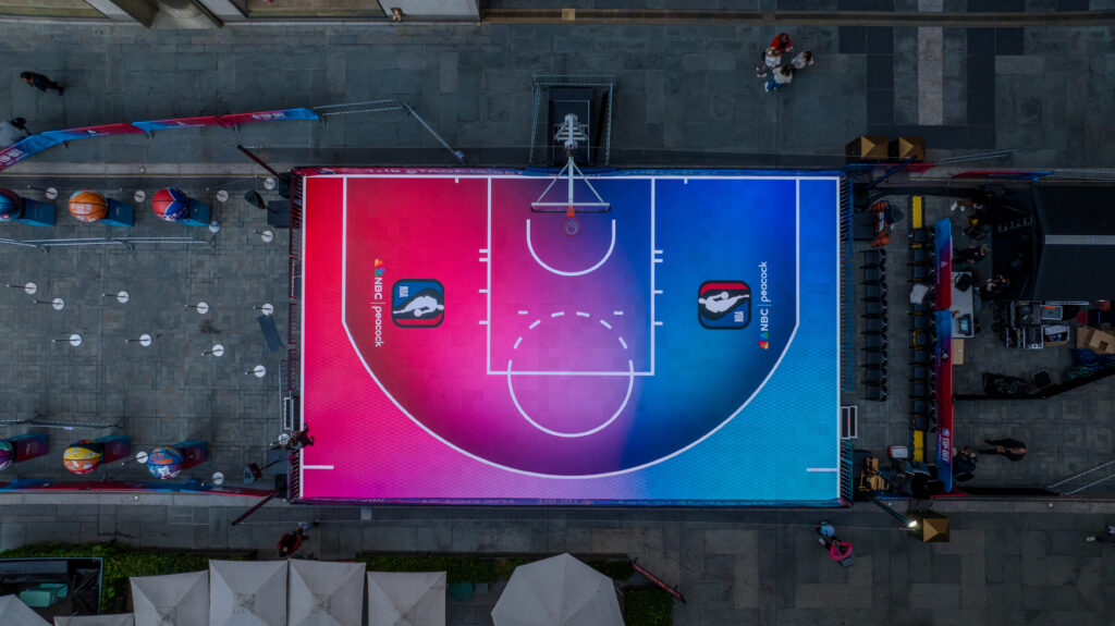 An overhead view of the pink and blue NBA on NBC basketball court.