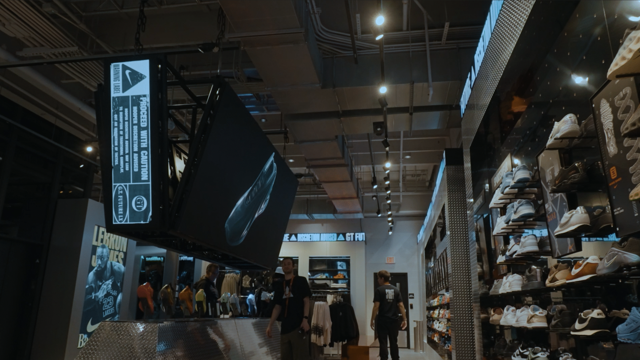 A hanging display and illuminated basketball graphics inside the Nike store activation.