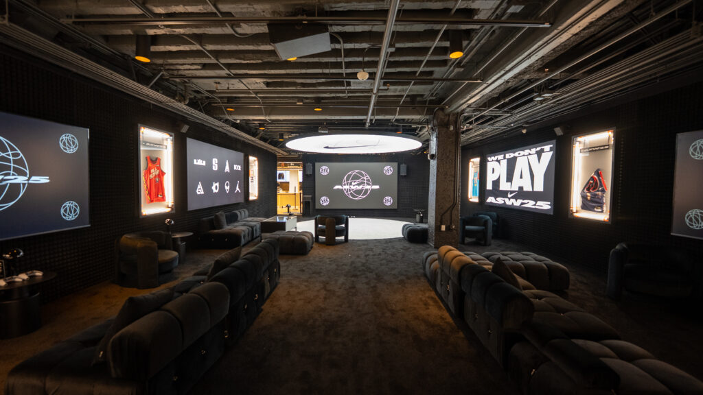 Rows of lounge seating face basketball displays in the Nike NBA2K lounge.