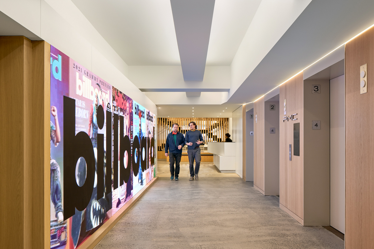 A long digital display runs along a hallway at Penske Media Corporation.