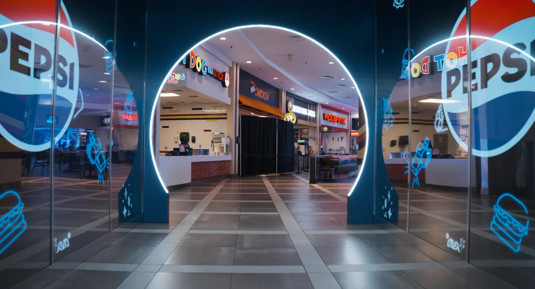 Curved Pepsi-branded displays flank an entrance to the activation.