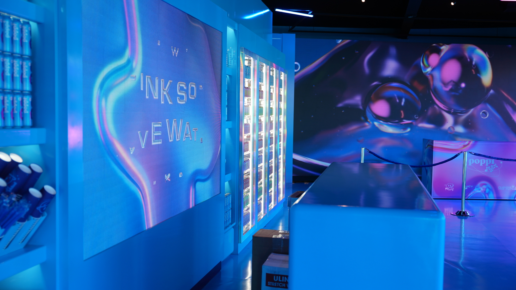 Blue-lit displays and colorful graphics inside the Poppi pop-up.