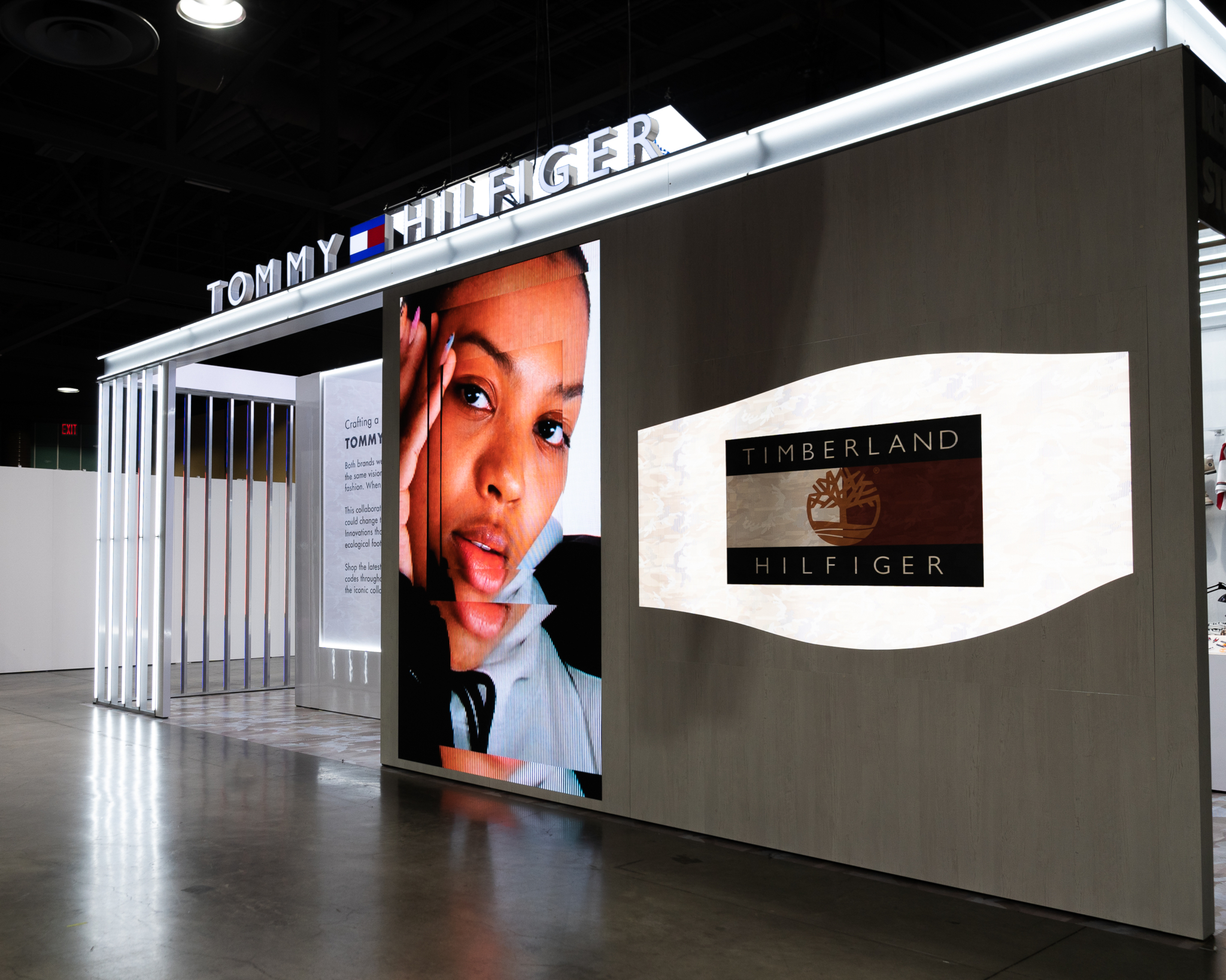 A Tommy Hilfiger-branded pavilion with a tall digital fashion display.
