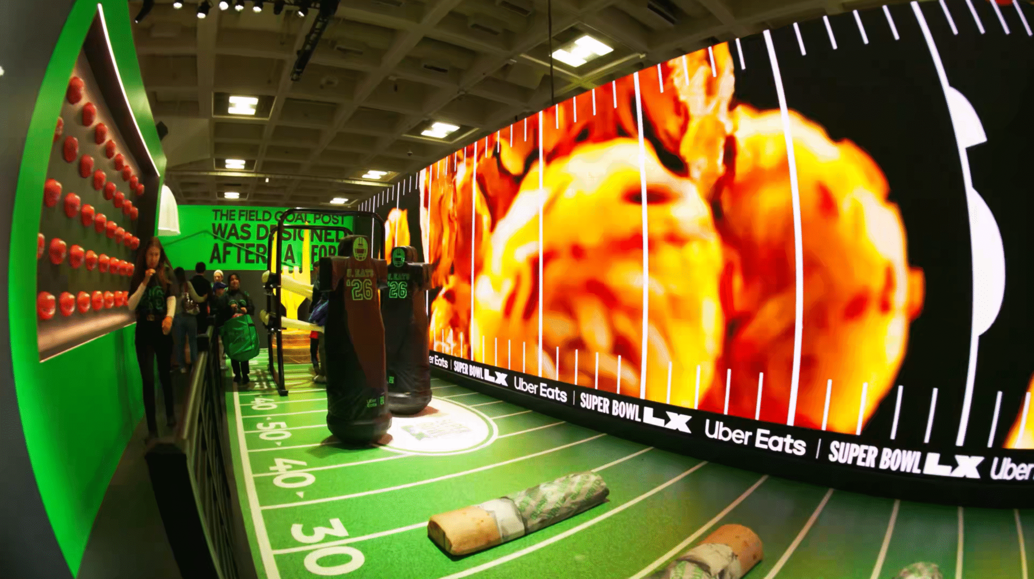 A curved display showing food imagery beside a green Uber Eats activity area.